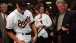 Baltimore Orioles player Cal Ripken autographs a baseball bat for President Clinton