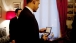 President Barack Obama looks at the Nobel Peace Prize medal for the first time