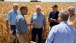 President Barack Obama talks with farmers during a tour of the McIntosh family 