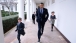 President Barack Obama runs along the Colonnade of the White House with Deputy National Security Advisor Denis McDonough's children