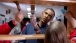 President Barack Obama helps stain shelves during a National Day of Service