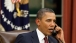 President Obama Talks on the Phone in the Oval Office