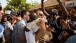 President Barack Obama and First Lady Michelle Obama greet residents as they walk towards the dock on Gorée Island