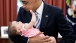President Barack Obama holds six-month-old Talia Neufeld
