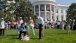 President Barack Obama cheers on kids taking part in the Easter Egg Roll on the South Lawn of the White House