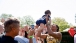 First Lady Michelle Obama lifts a baby at Easter Egg Roll