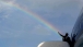 President Obama waves under a rainbow