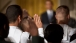 members Of The Military Raise Their Hands During A Naturalization Ceremony