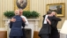 President Obama hugs Kristie Canegallo and Vice President Biden hugs Denis McDonough