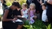 First Lady Michelle Obama Signs A Paper For Children