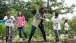 The First Lady shows students how to use gardening tools