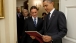 President Barack Obama Looks At A Photograph Of Kate Puzey