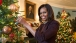 First Lady Michelle Obama poses with the 2014 White House Christmas ornament