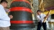 President Obama rings a large bell during a tour of the Shwedagon Pagoda