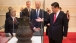 Vice President Joe Biden talks and Chinese President Xi Jinping look at artifacts