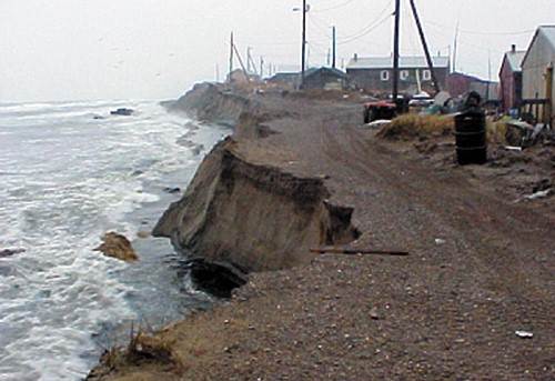 Waves break at the base of the bluff at Shishmaref, where severe coastal erosion  threatens this Iñupiat village on the Seward Peninsula in western Alaska. Photo: NOAA