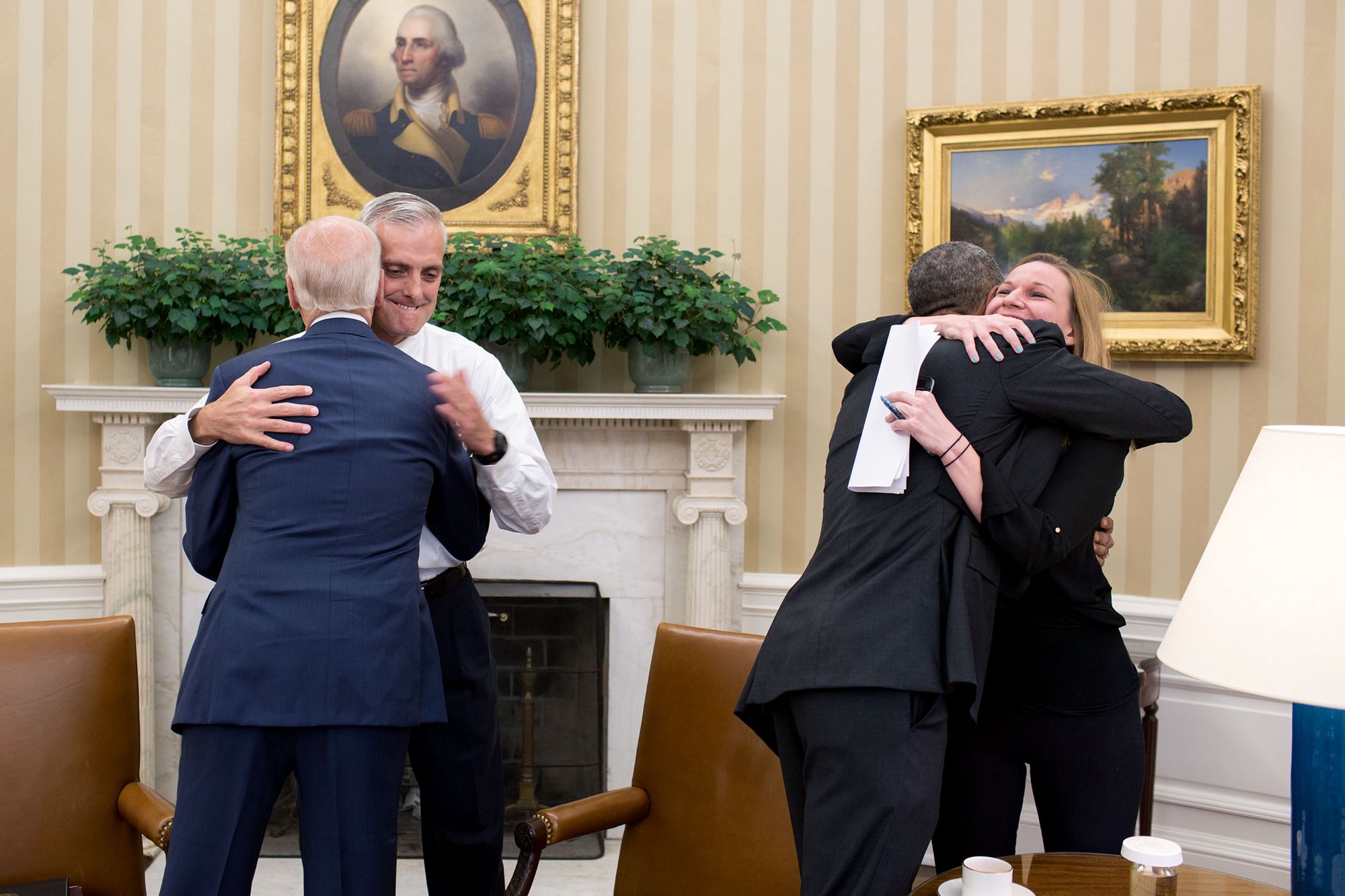 The President hugs Kristie Canegallo as the Vice President hugs McDonough. (Official White House Photo by Pete Souza)