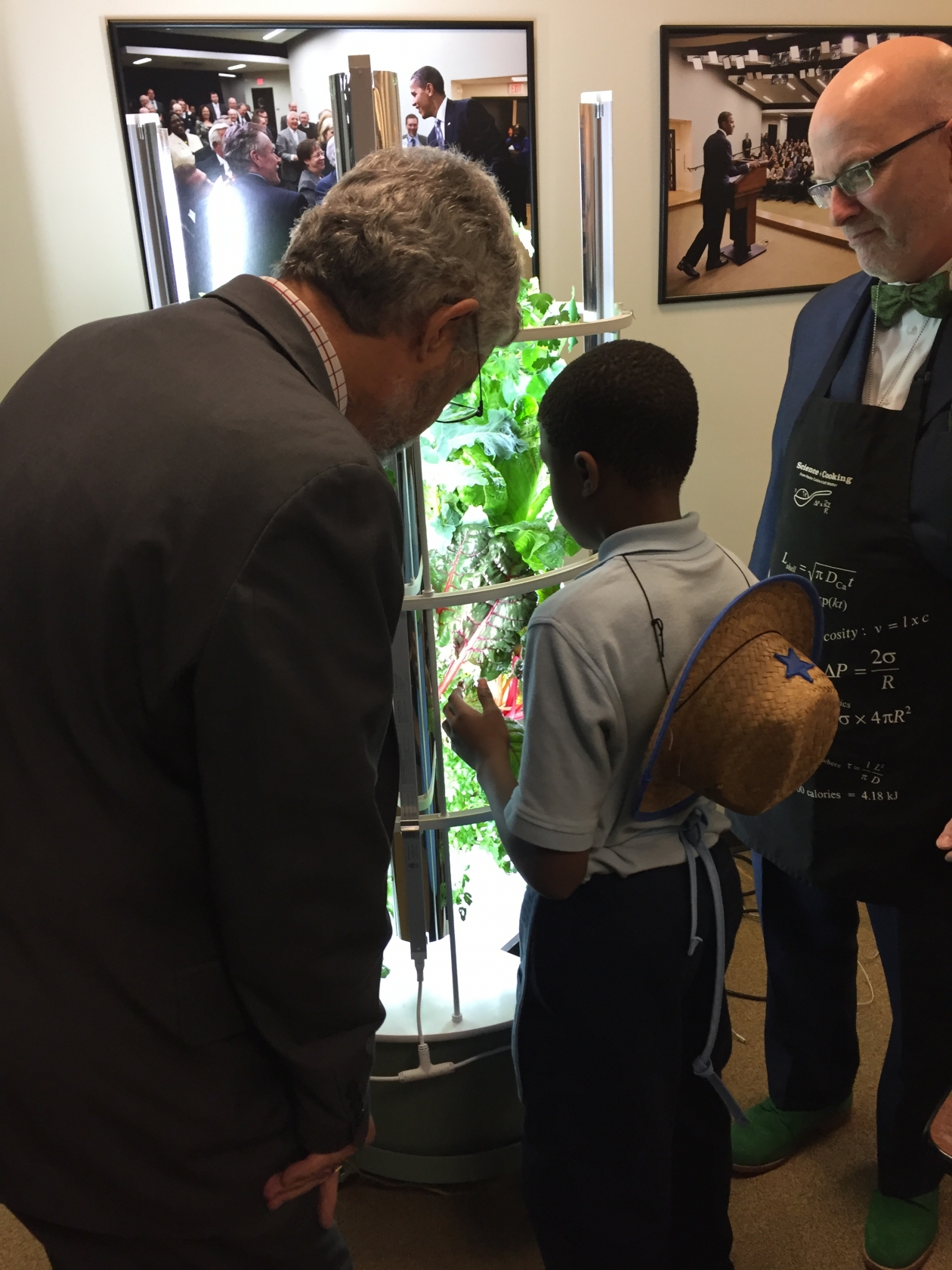 OSTP Director Dr. John Holdren listens as a student explains a hydroponics exhibit at the 2016 State of STEM event.