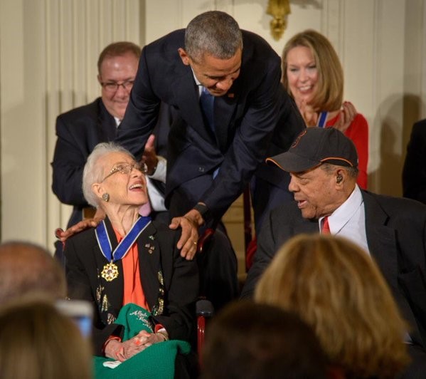 President Barack Obama presents former NASA mathematician Katherine Johnson with the Presidential Medal of Freedom, as professional baseball player Willie Mays, right, looks on, Tuesday, Nov. 24, 2015, during a ceremony in the East Room of the White House in Washington. (Photo Credit: NASA/Bill Ingalls).