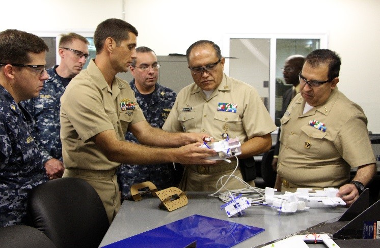 Lieutenant Todd Coursey discusses project based education and training with delegates from the Mexican Navy.
