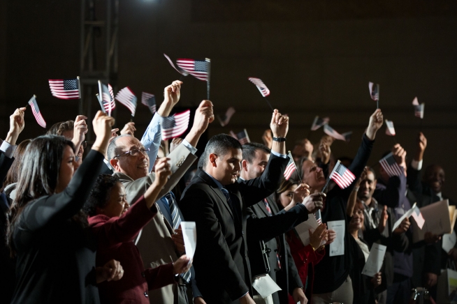  Newly naturalized citizens wave American flags