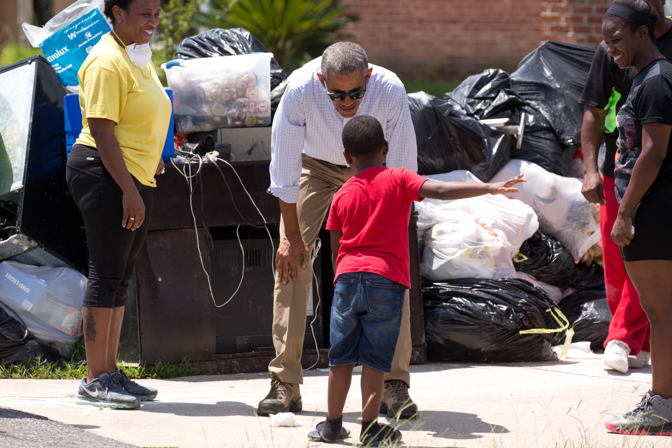 President Barack Obama views a flood-damaged neighborhood and talks with residents of the Castle Place subdivision in Zachary, near Baton Rouge, LA.