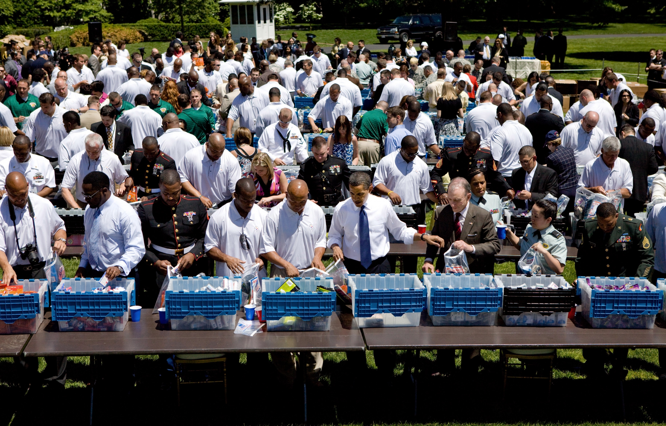 President Obama and the Super Bowl champion Pittsburgh Steelers pack care packages for distribution by the USO during an event on the South Lawn