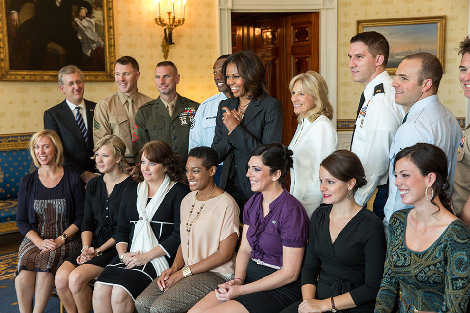 First Lady Michelle Obama and Dr. Jill Biden join USO honorees for a group photo in the Blue Room of the White House
