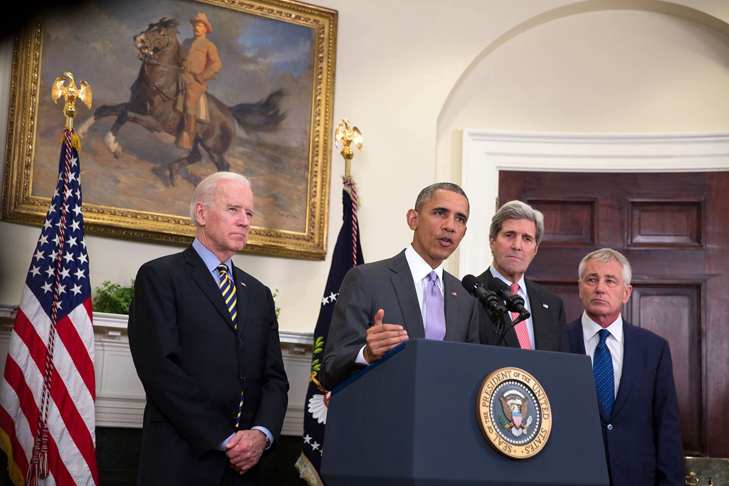 President Obama speaks from a podium surrounded by Vice President Joe Biden, Secretary of State John Kerry, and Secretary of Defense Chuck Hagel.
